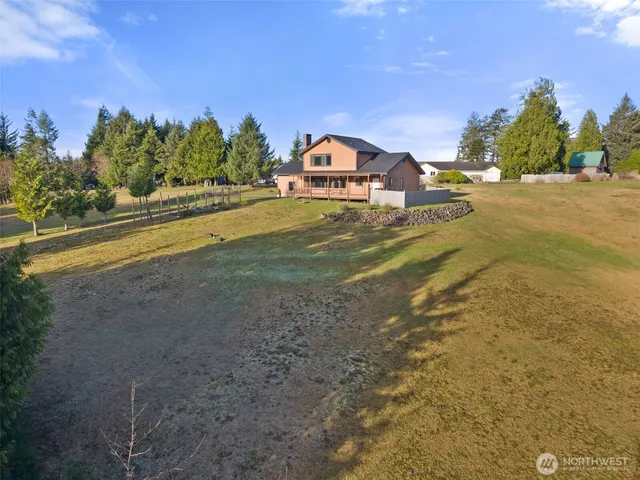 a front view of a house with a yard and mountain view