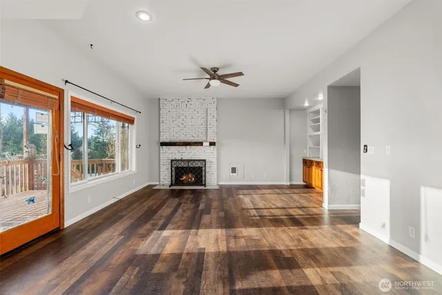 a view of empty room with a fireplace and fan