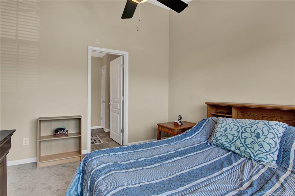 232 Dawn Mist Lane, Unit 40 Fort Mill, SC 29708 - Photo 15 of 28 a bedroom with a bed and painting on the wall