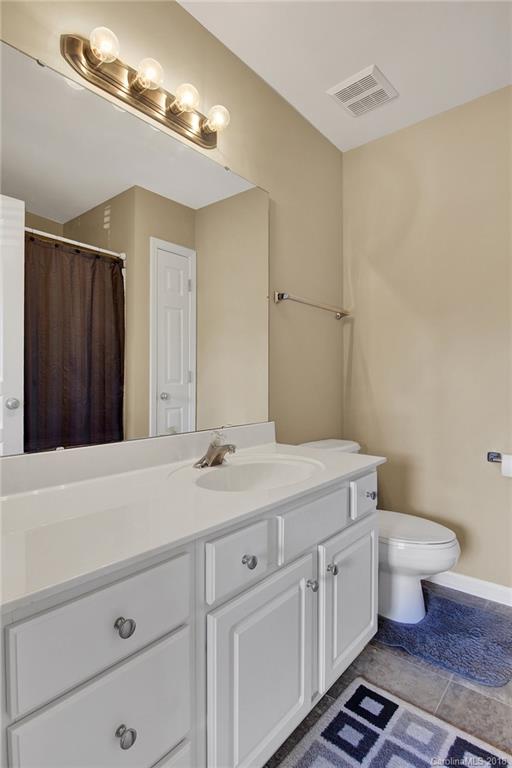 232 Dawn Mist Lane, Unit 40 Fort Mill, SC 29708 - Photo 16 of 28 a bathroom with a granite countertop sink a toilet and a mirror