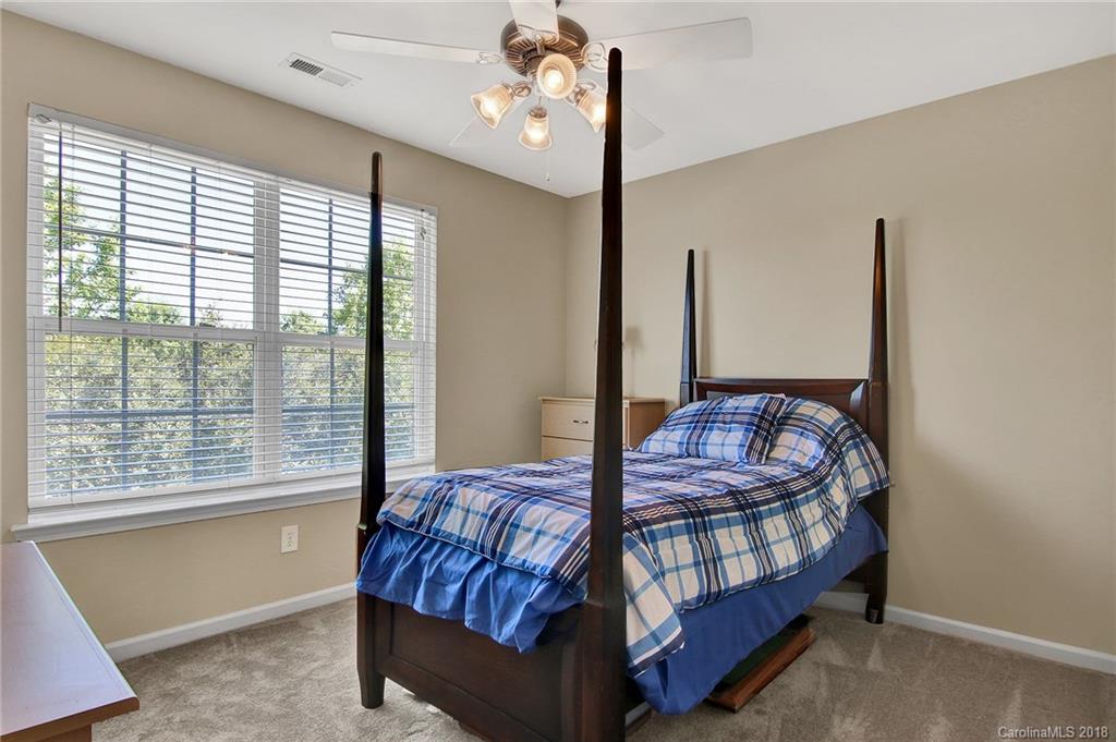 232 Dawn Mist Lane, Unit 40 Fort Mill, SC 29708 - Photo 17 of 28 a bed sitting in a bedroom next to a window