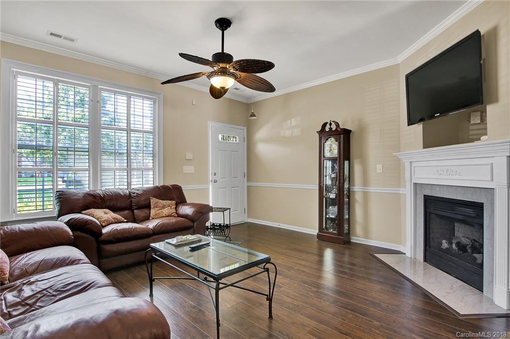 232 Dawn Mist Lane, Unit 40 Fort Mill, SC 29708 - Photo 4 of 28 a living room with furniture a flat screen tv and a fireplace