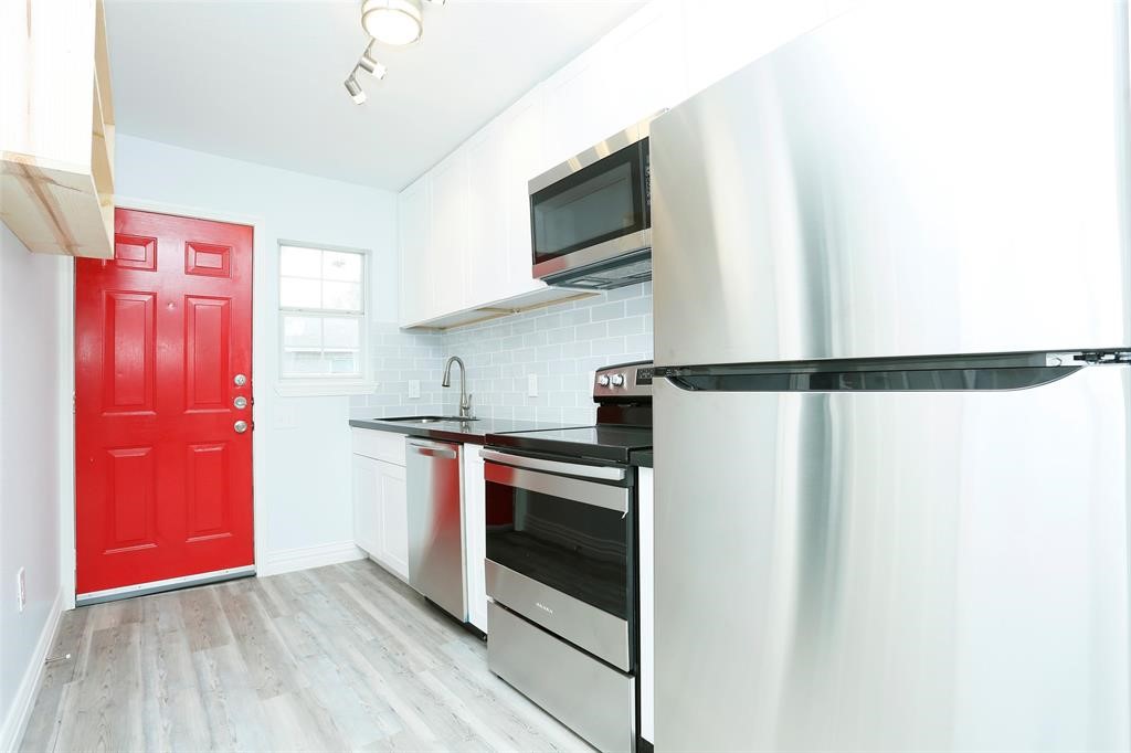 3603 Bastrop Street, Unit 1 Houston, TX 77004 - Photo 5 of 10 a kitchen with stainless steel appliances granite countertop a refrigerator and a microwave