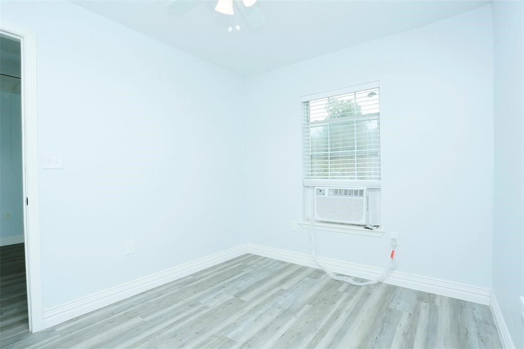 3603 Bastrop Street, Unit 1 Houston, TX 77004 - Photo 7 of 10 an empty room with wooden floor and windows