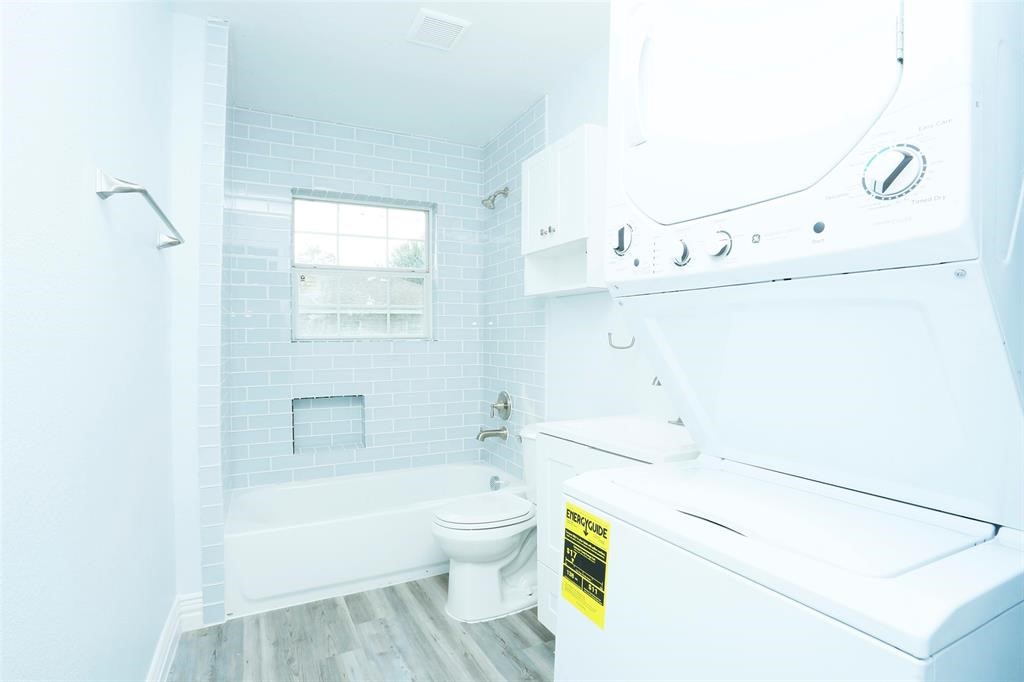 3603 Bastrop Street, Unit 1 Houston, TX 77004 - Photo 9 of 10 a bathroom with a bathtub sink vanity mirror and toilet
