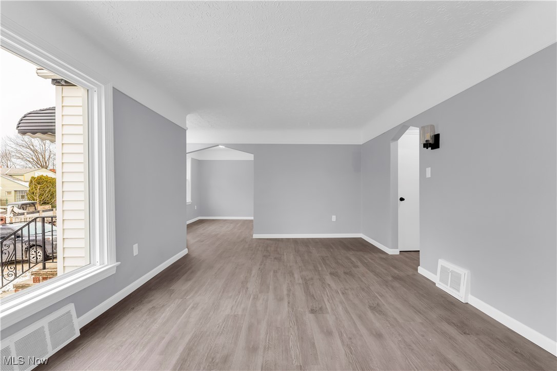 953 Whitby Road Cleveland Heights, OH 44112 - Photo 5 of 27 Unfurnished room featuring a textured ceiling and wood finished floors