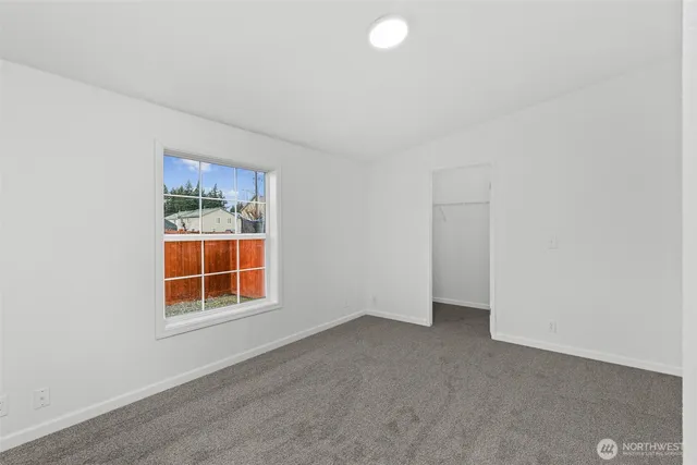 a bathroom with a granite countertop double vanity sink and a mirror