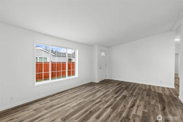 a view of a room with wooden floor