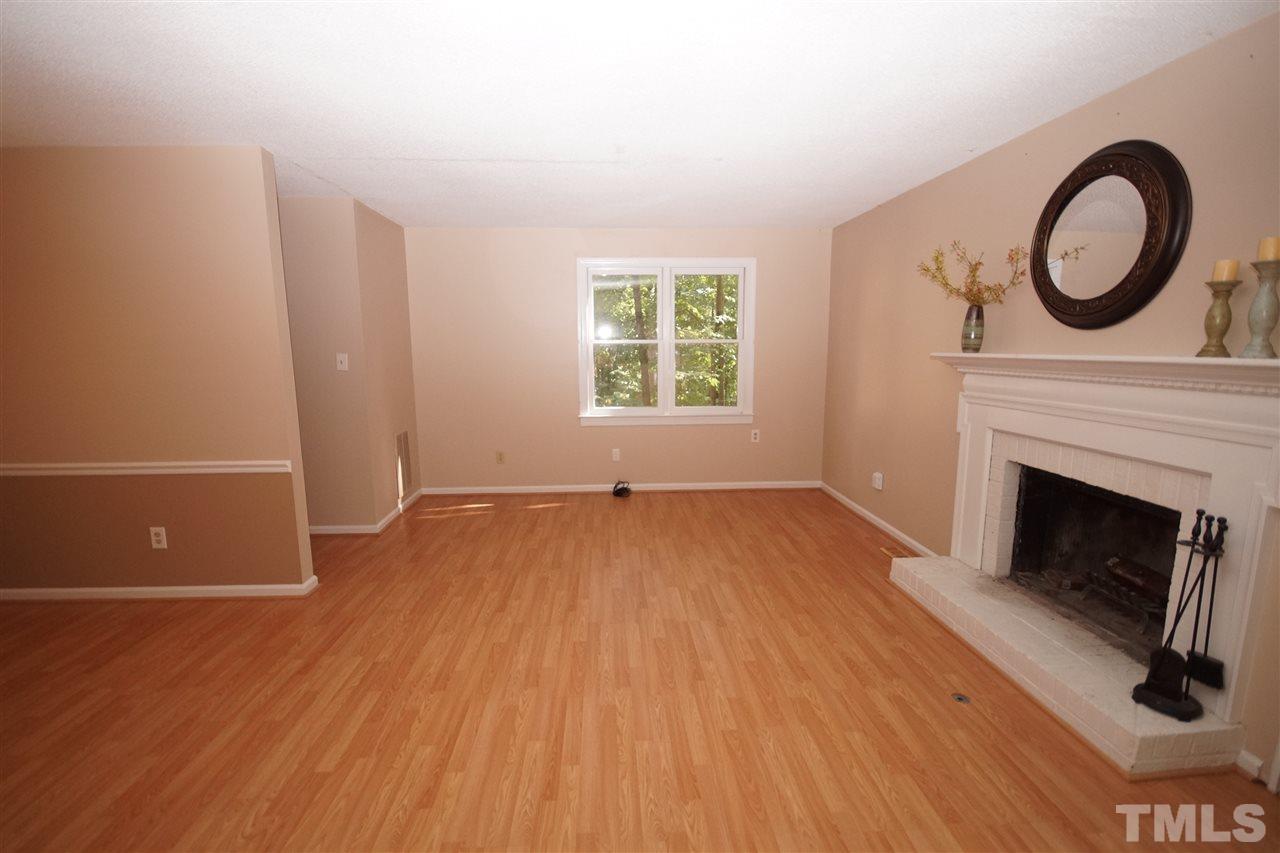 5719 Pool Side Drive Raleigh, NC 27612 - Photo 12 of 23 a view of an empty room with wooden floor and a window