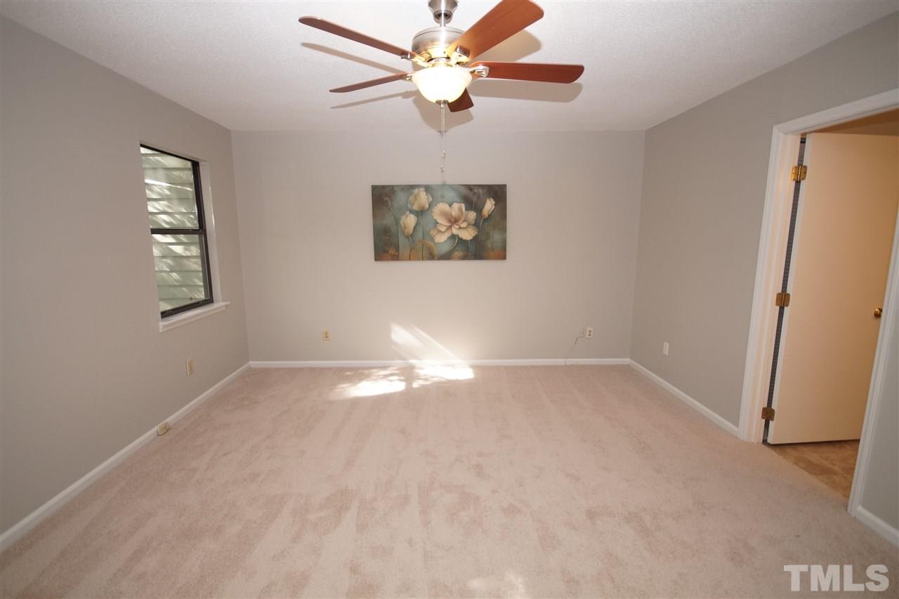 5719 Pool Side Drive Raleigh, NC 27612 - Photo 15 of 23 an empty room with windows and fan
