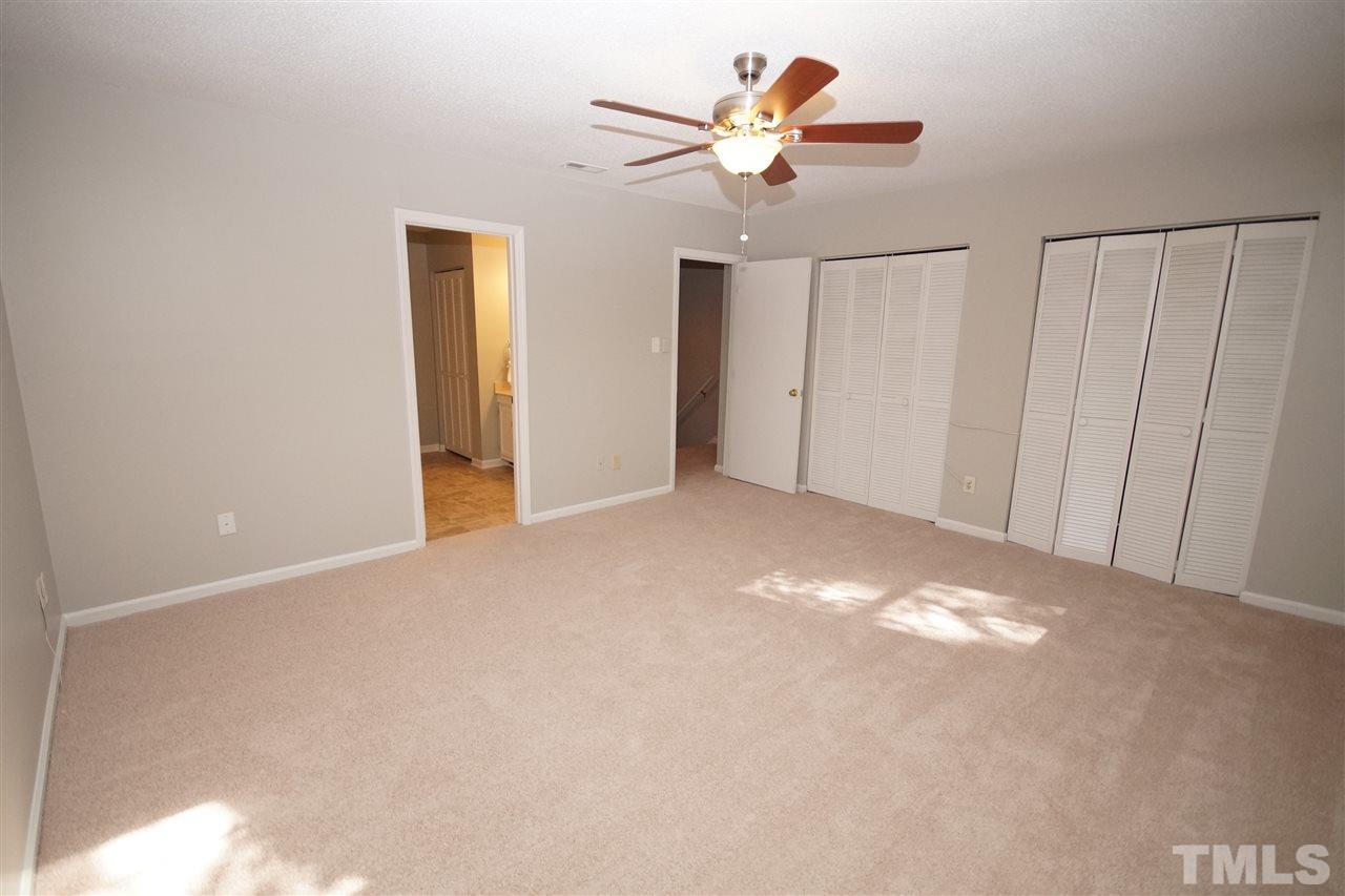 5719 Pool Side Drive Raleigh, NC 27612 - Photo 16 of 23 an empty room with a ceiling fan and a window