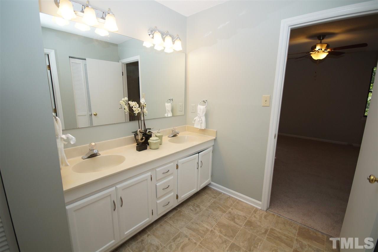 5719 Pool Side Drive Raleigh, NC 27612 - Photo 17 of 23 a bathroom with a double vanity sink and a mirror