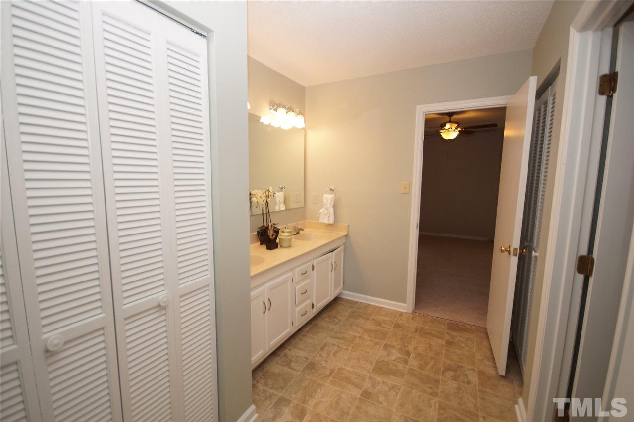 5719 Pool Side Drive Raleigh, NC 27612 - Photo 18 of 23 a bathroom with a tub sink and mirror