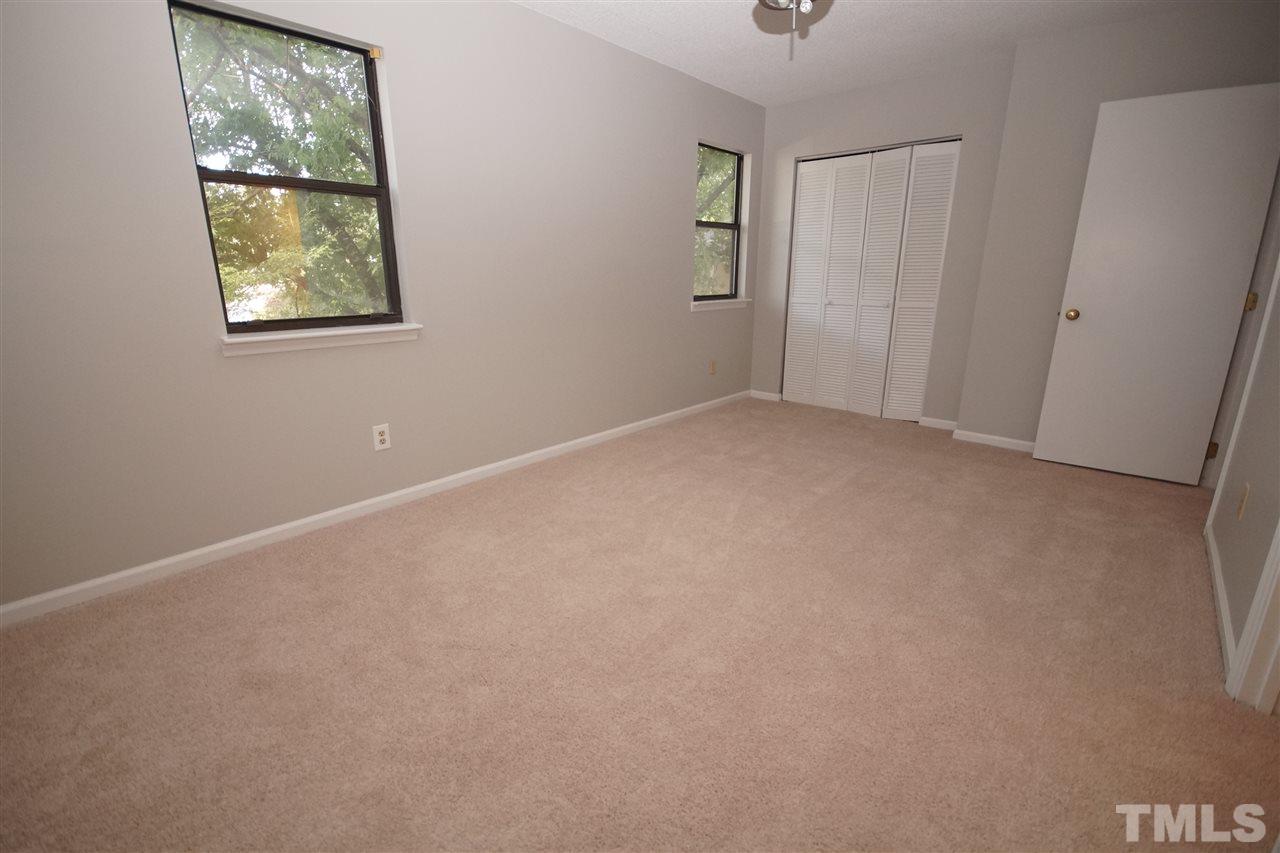 5719 Pool Side Drive Raleigh, NC 27612 - Photo 20 of 23 an empty room with windows and closet