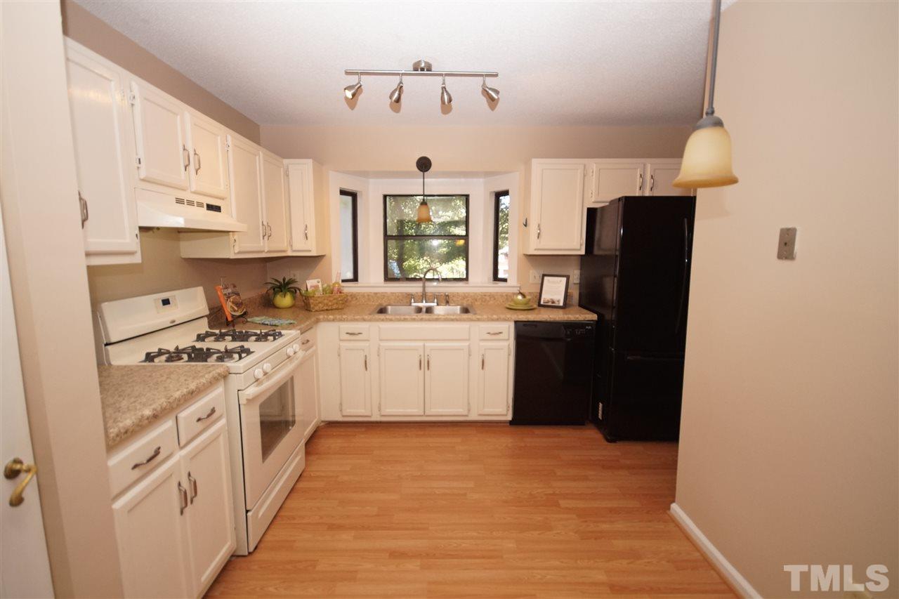 5719 Pool Side Drive Raleigh, NC 27612 - Photo 4 of 23 a kitchen with a sink stove and refrigerator