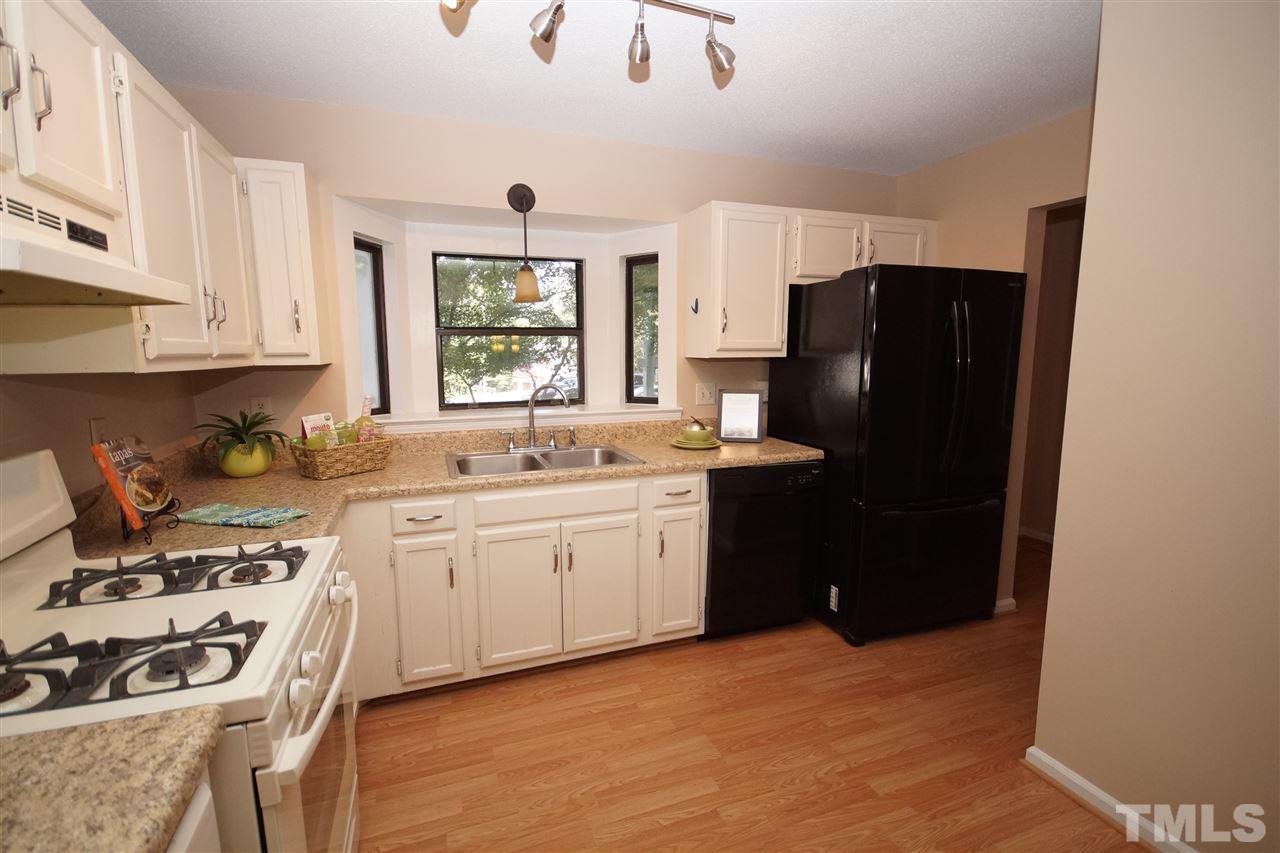 5719 Pool Side Drive Raleigh, NC 27612 - Photo 5 of 23 a kitchen with a sink stove and refrigerator