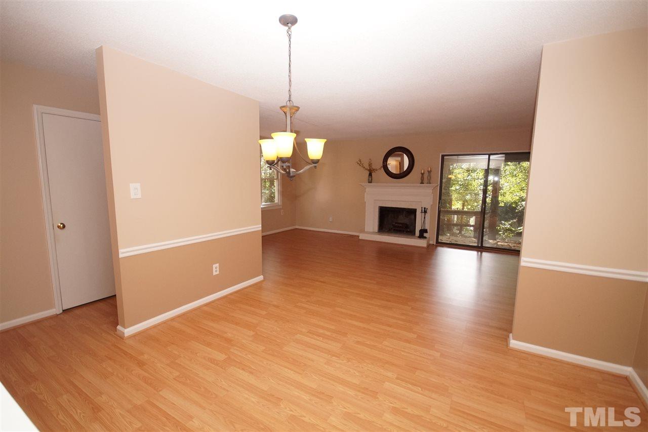 5719 Pool Side Drive Raleigh, NC 27612 - Photo 6 of 23 a view of a livingroom with a fireplace wooden floor and window