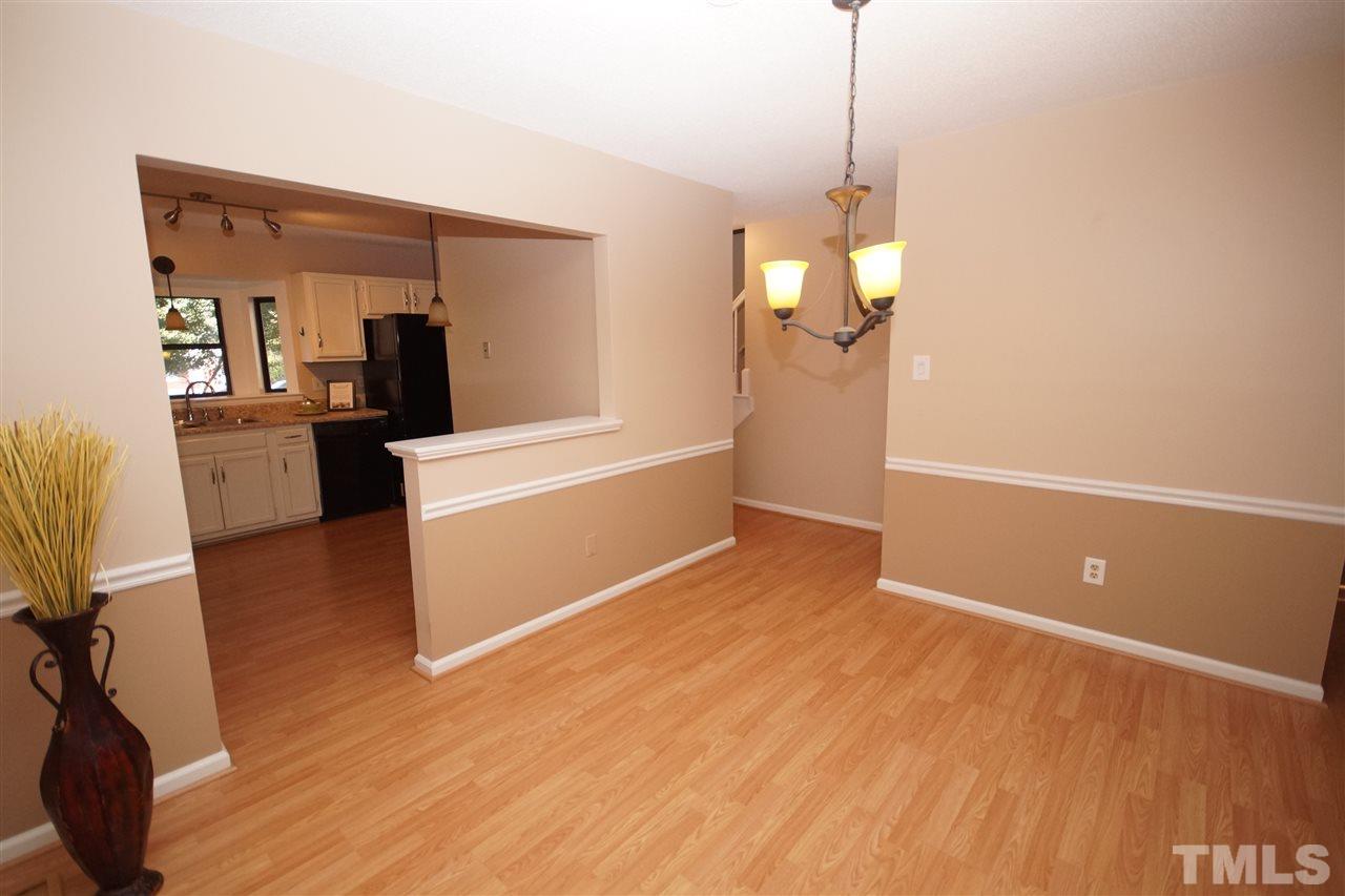 5719 Pool Side Drive Raleigh, NC 27612 - Photo 7 of 23 a view of a room with wooden floor and a ceiling fan