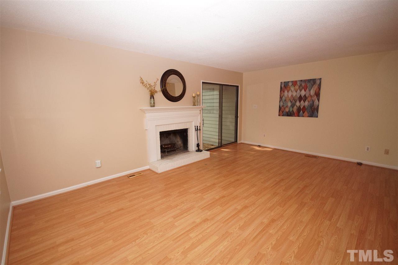 5719 Pool Side Drive Raleigh, NC 27612 - Photo 9 of 23 a view of empty room with a fireplace