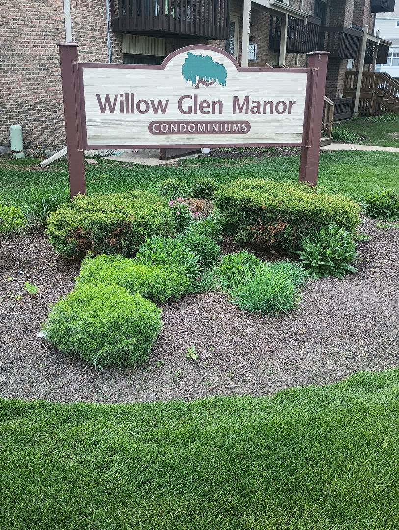 266 12th Street, Unit 3B Wheeling, IL 60090 - Photo 6 of 6 a sign that is sitting on a brick wall