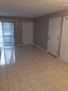a view of an empty room and wooden floor