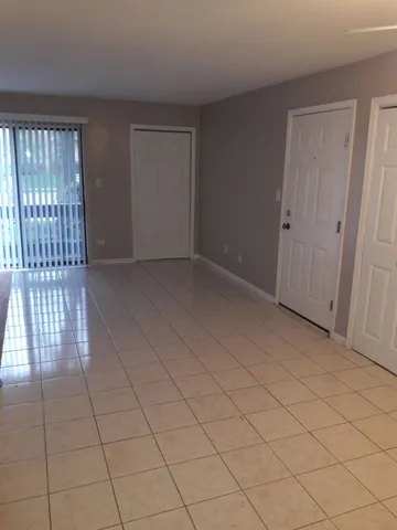 a view of an empty room and wooden floor