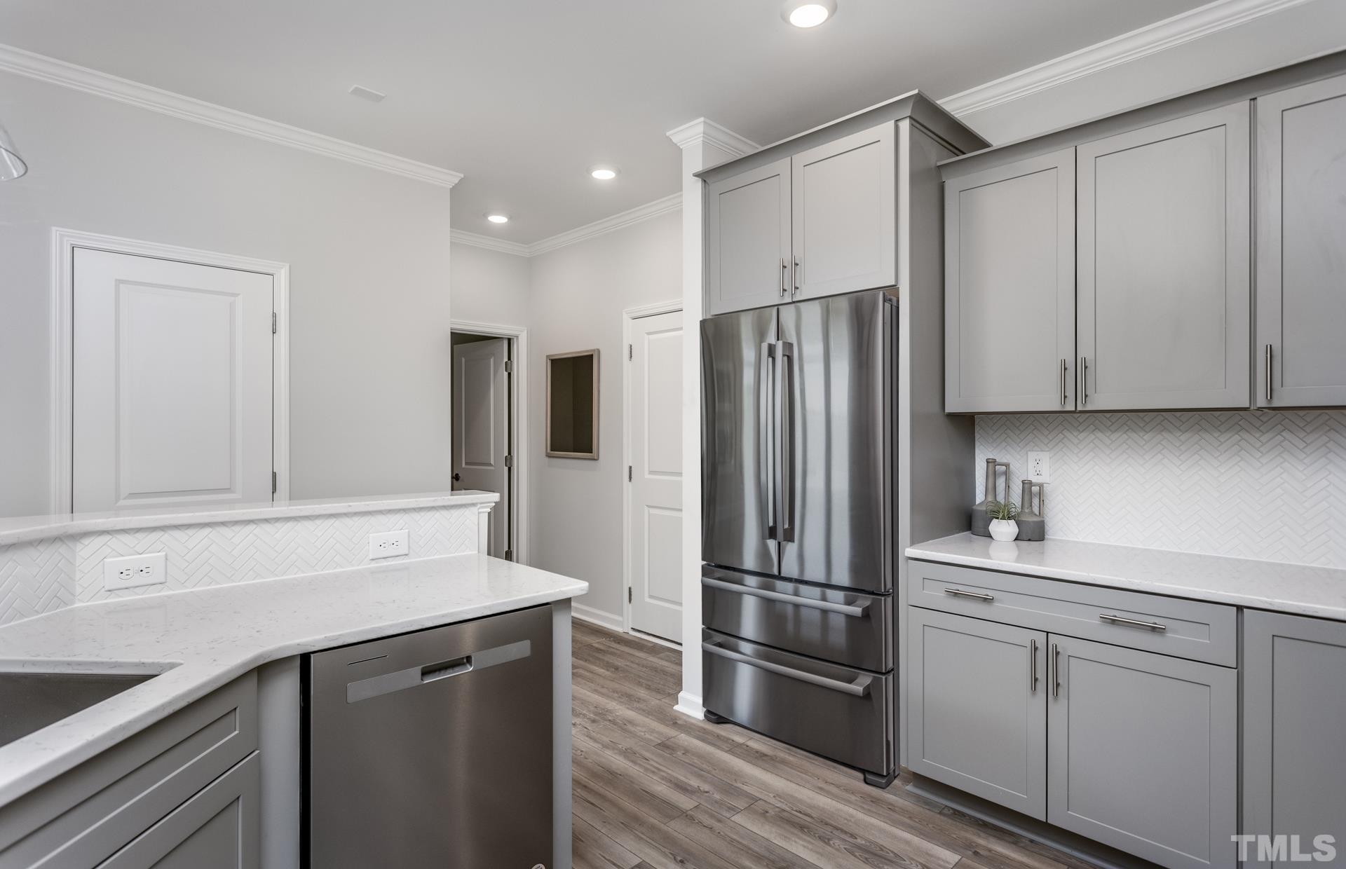 2400 Hedge Maple Drive, Unit ROYAL Raleigh, NC 27603 - Photo 13 of 16 a kitchen with a refrigerator sink and cabinets