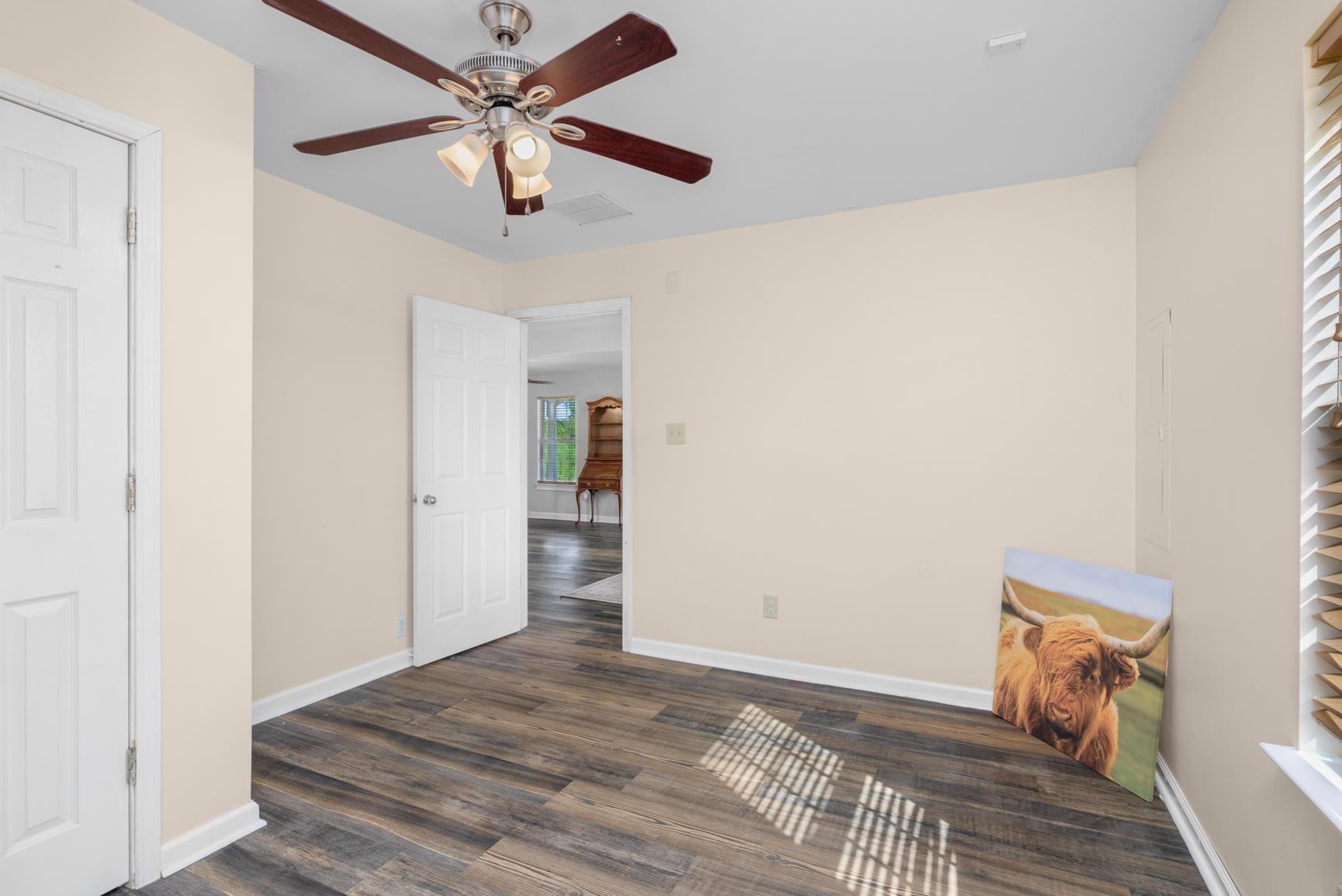 420 Sanford Road Covington, TN 38019 - Photo 16 of 27 Wood-finish flooring, ceiling fan with integrated lighting, white interior doors, and neutral wall tones