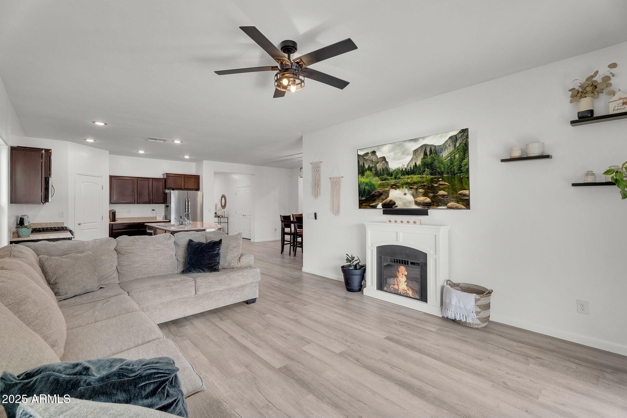 6579 West Georgetown Way Florence, AZ 85132 - Photo 12 of 60 a living room with furniture a fireplace and a flat screen tv
