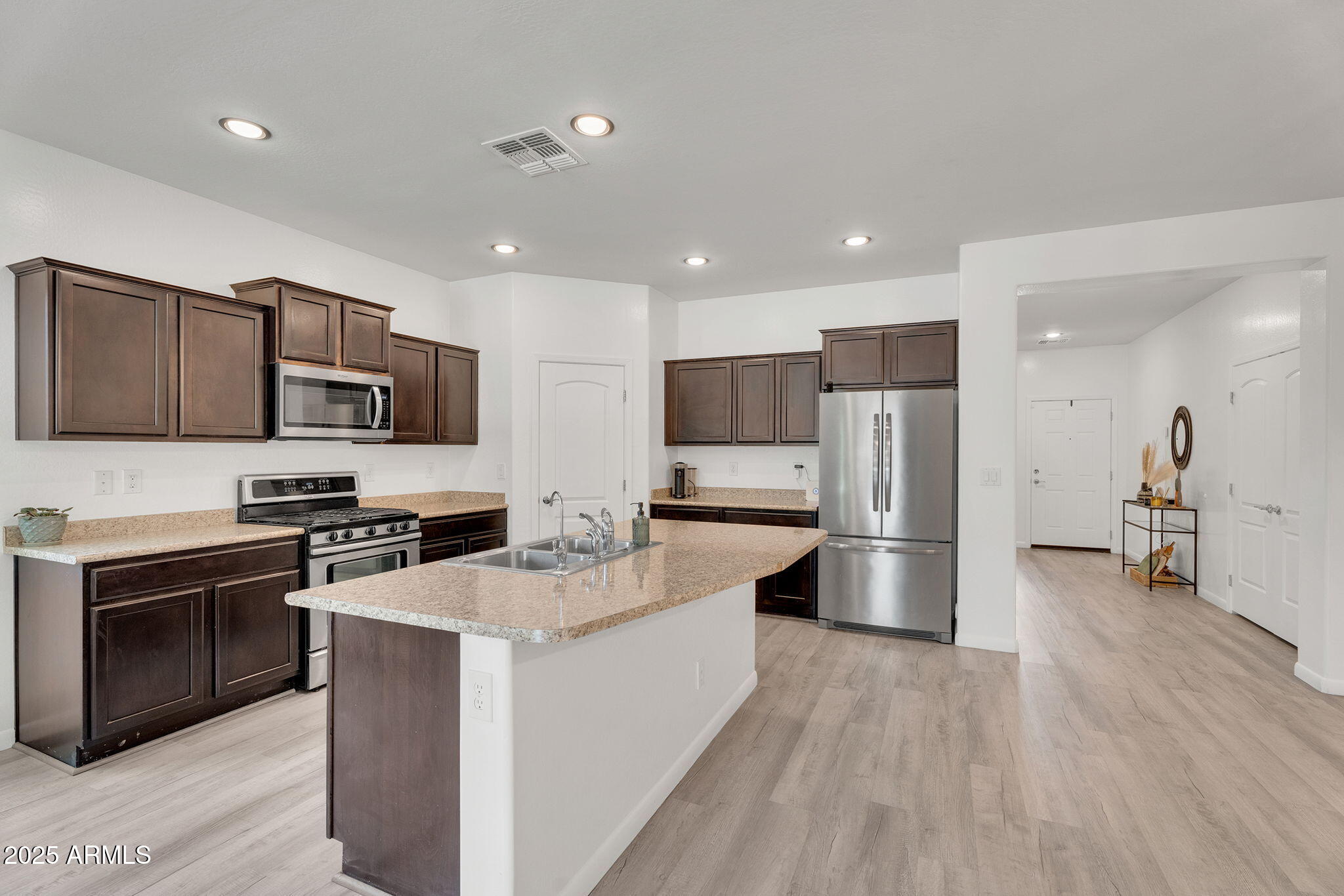 6579 West Georgetown Way Florence, AZ 85132 - Photo 15 of 60 a large kitchen with stainless steel appliances and a stove top oven