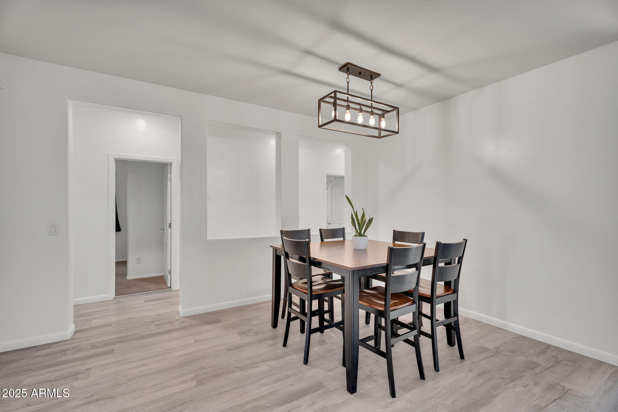 6579 West Georgetown Way Florence, AZ 85132 - Photo 18 of 60 a view of a dining room with furniture wooden floor and chandelier