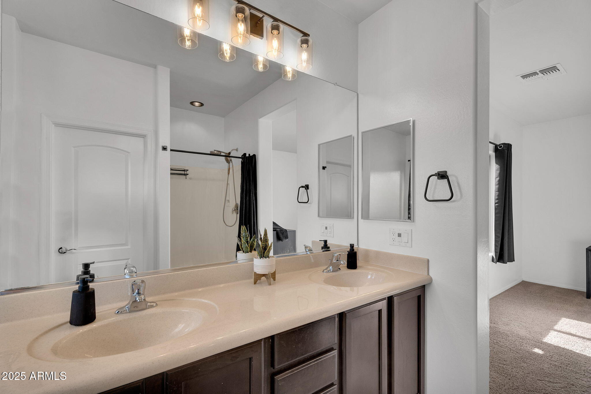 6579 West Georgetown Way Florence, AZ 85132 - Photo 26 of 60 a bathroom with double vanity sinks and a mirror