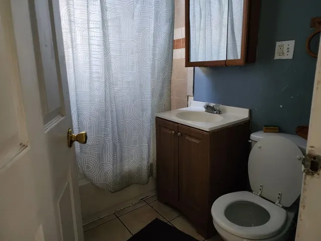 a bathroom with a toilet a sink and a window
