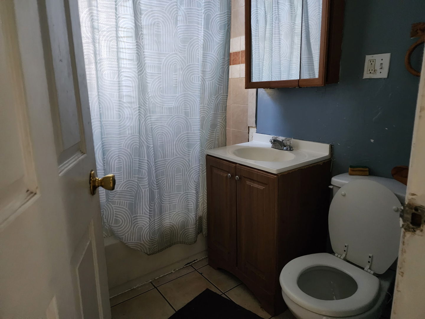 5718 South Green Street Chicago, IL 60621 - Photo 11 of 17 a bathroom with a toilet a sink and a window