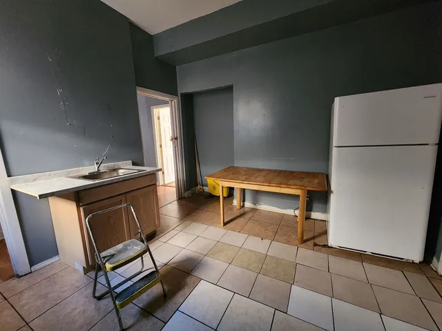 a room with furniture and a refrigerator