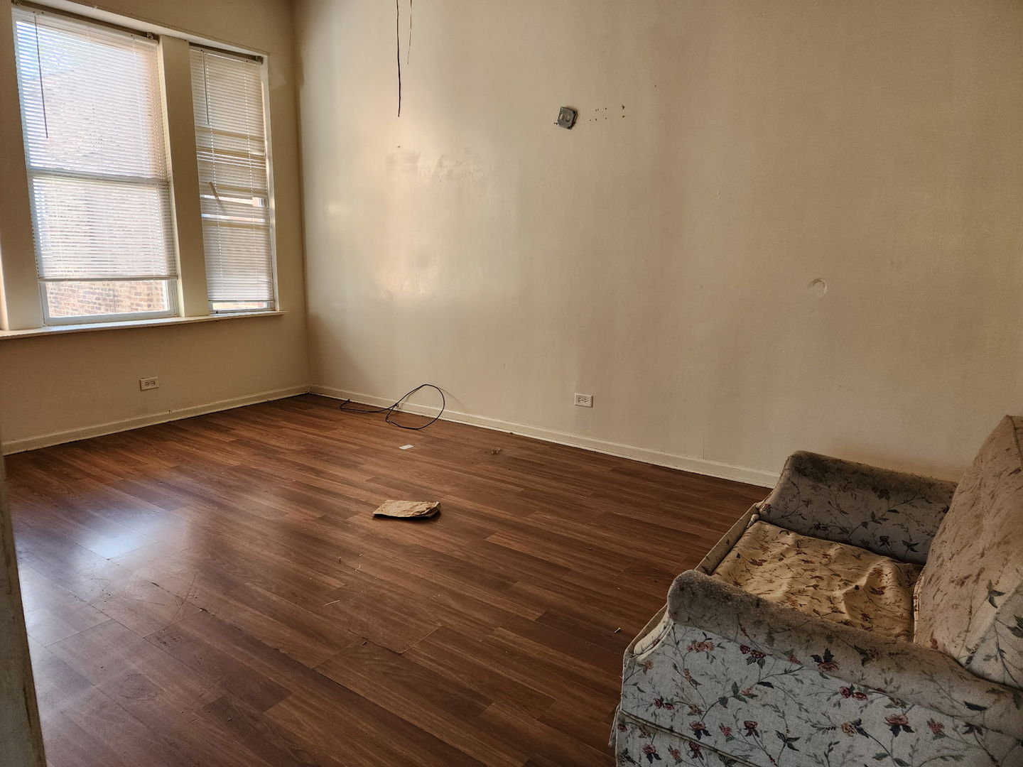 5718 South Green Street Chicago, IL 60621 - Photo 5 of 17 an empty room with wooden floor and windows