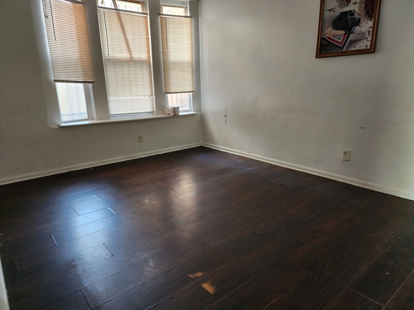 5718 South Green Street Chicago, IL 60621 - Photo 7 of 17 an empty room with wooden floor and windows