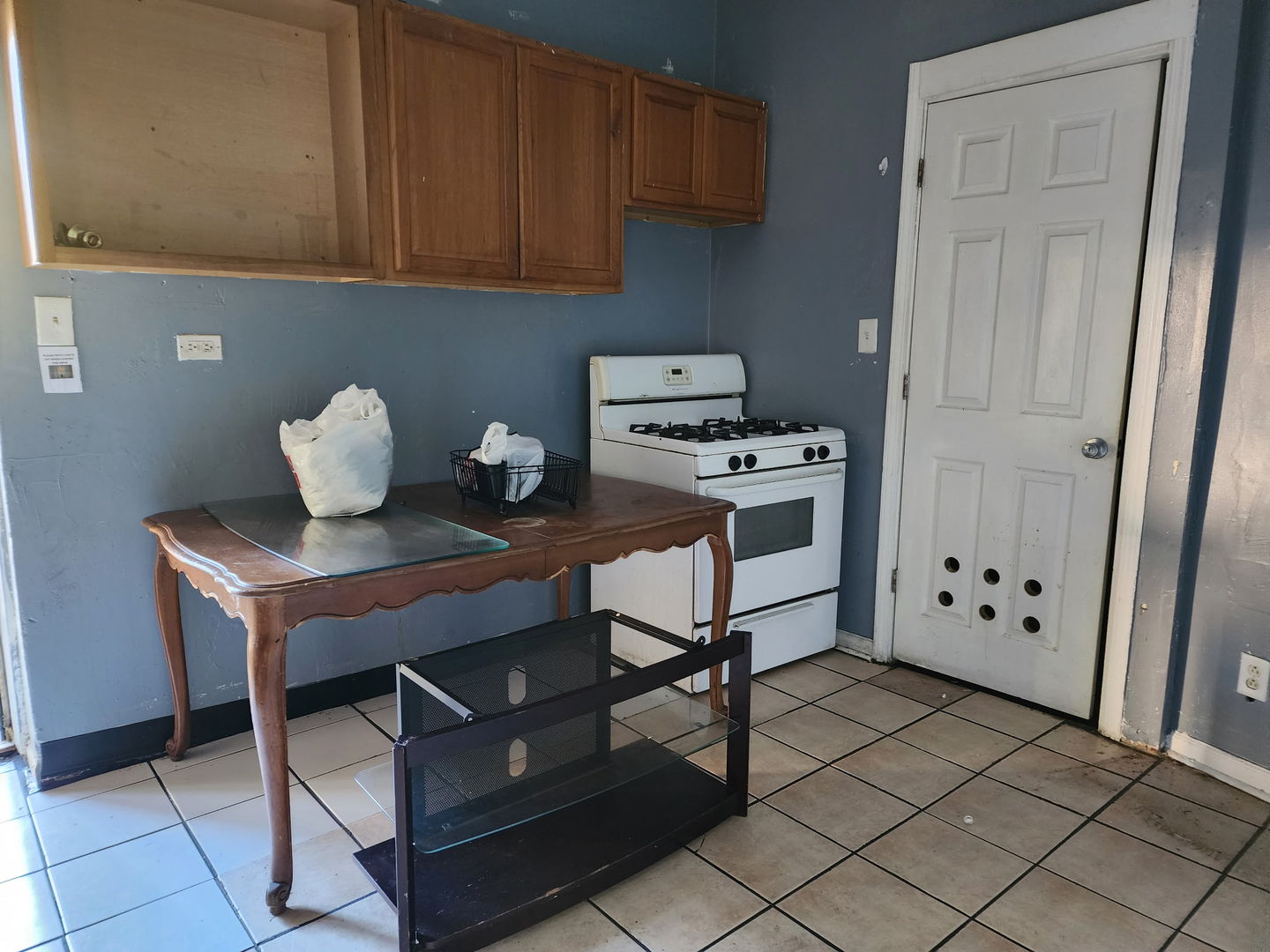 5718 South Green Street Chicago, IL 60621 - Photo 9 of 17 a kitchen with appliances cabinets and a counter top space