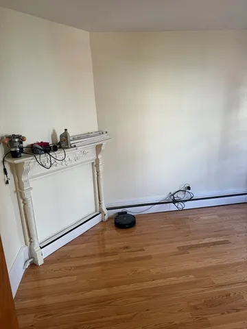 a view of a room with wooden floor and sink