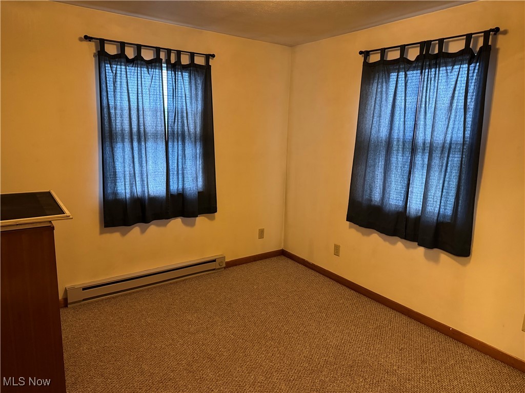 729 Donohue Road Evans, WV 25241 - Photo 7 of 8 Spare room with baseboard heating, baseboards, and carpet