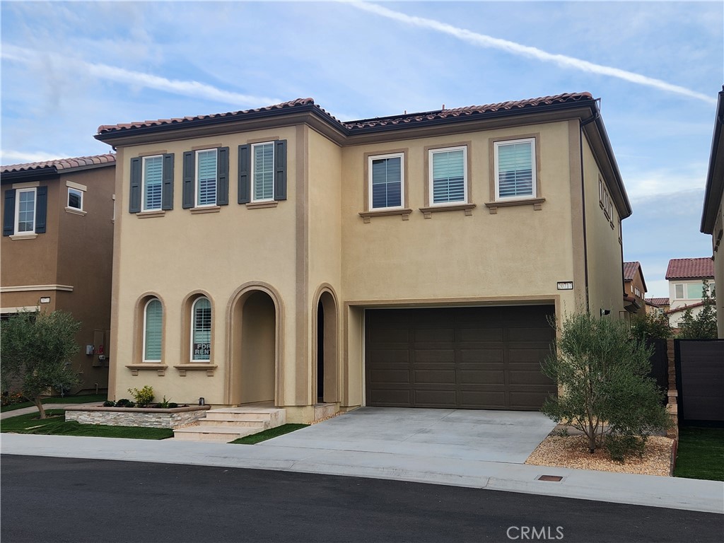 20717 Pine Cone Circle Porter Ranch, CA 91326 - Photo 1 of 31 a front view of a house with garden