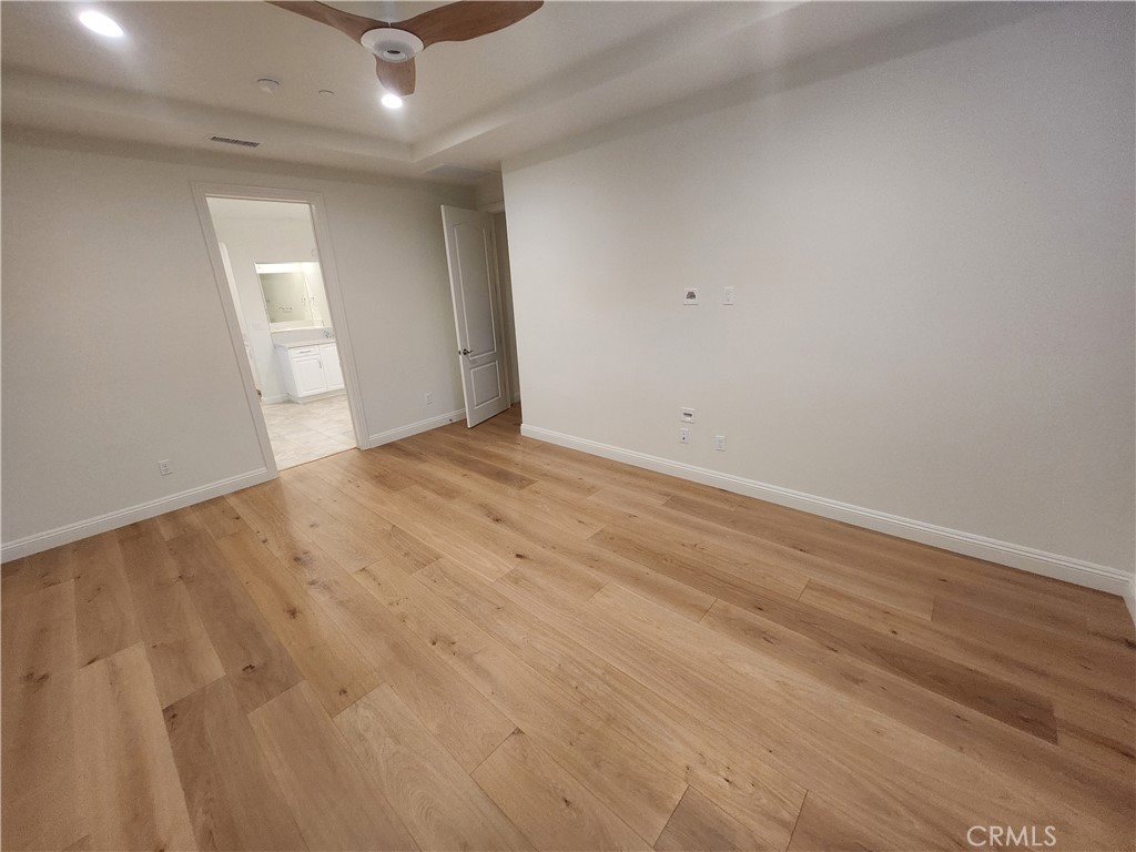 20717 Pine Cone Circle Porter Ranch, CA 91326 - Photo 11 of 31 an empty room with wooden floor and windows