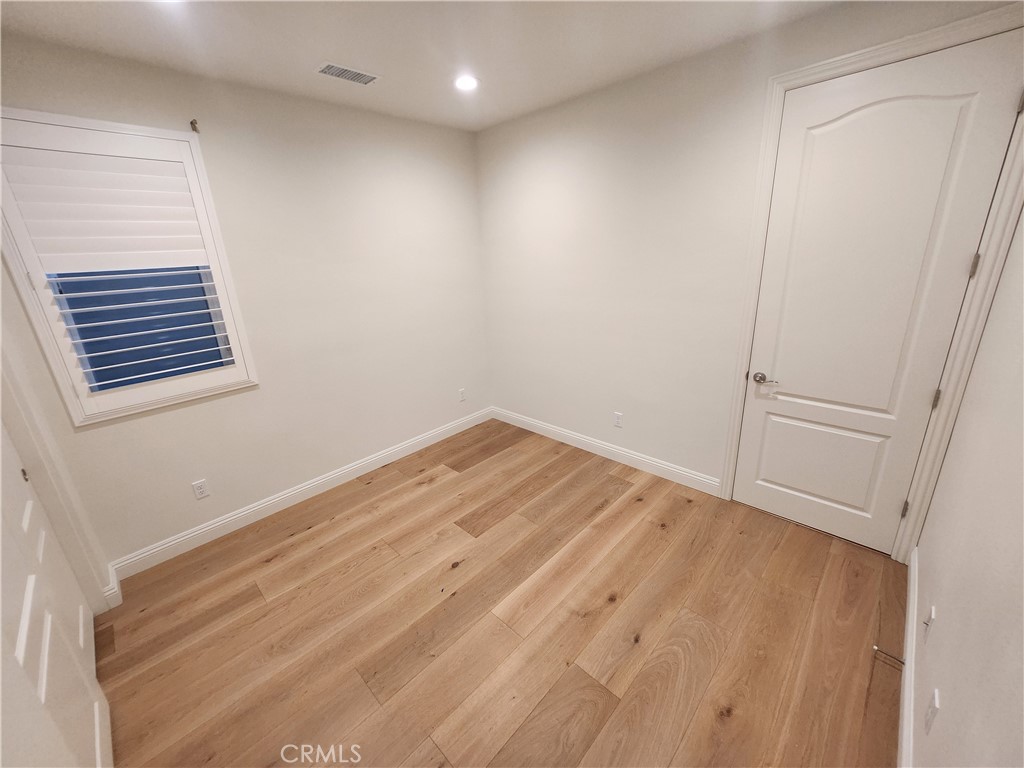 20717 Pine Cone Circle Porter Ranch, CA 91326 - Photo 17 of 31 a view of empty room with wooden floor