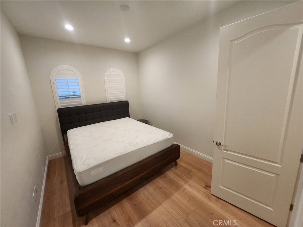 20717 Pine Cone Circle Porter Ranch, CA 91326 - Photo 18 of 31 a room with a bed and a night stand
