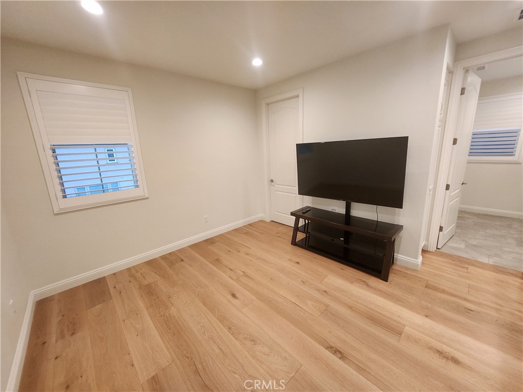 20717 Pine Cone Circle Porter Ranch, CA 91326 - Photo 19 of 31 a view of a livingroom with wooden floor and a flat screen tv