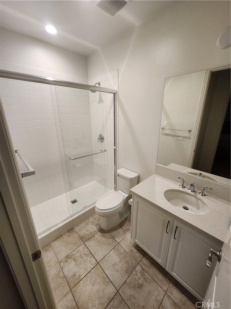 20717 Pine Cone Circle Porter Ranch, CA 91326 - Photo 20 of 31 a bathroom with a granite countertop sink toilet a mirror and shower