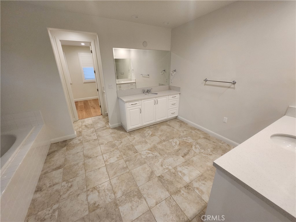 20717 Pine Cone Circle Porter Ranch, CA 91326 - Photo 23 of 31 a bathroom with a sink a toilet and mirror