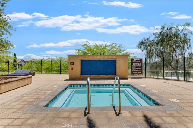 a swimming pool with outdoor seating and yard