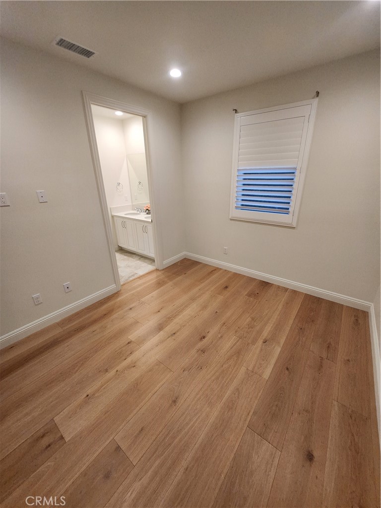 20717 Pine Cone Circle Porter Ranch, CA 91326 - Photo 26 of 31 an empty room with wooden floor and windows