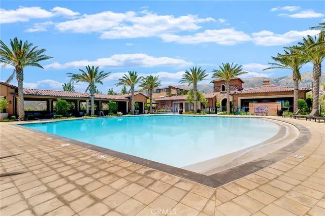 a view of yard with swimming pool and lawn chairs